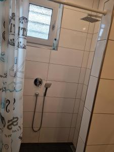 a shower with a shower curtain in a bathroom at Erdgeschosswohnung in Marl in Marl