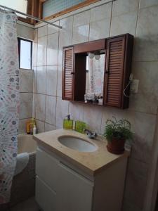 a bathroom with a sink and a mirror and a shower at Homestay Iquique in Iquique +18 photos