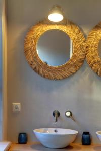 a bathroom with a sink and a mirror on the wall at Villa Azura in Tholen