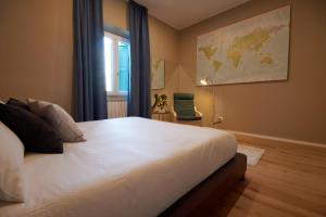 a bedroom with a large white bed and a window at Due Strade APT - Dolcevita Holiday in Florence