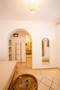 a living room with a table and a refrigerator at Riad Rahal in Marrakech