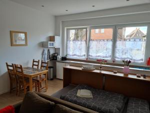 a living room with a couch and a table and two windows at Erdgeschosswohnung in Marl in Marl