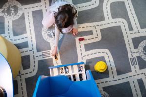 a little girl playing with a toy city on a floor at LIHO - einfach Lübeck in Lübeck