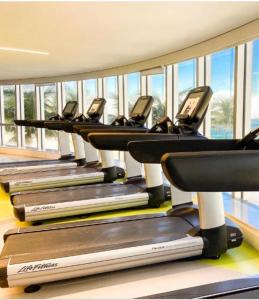 a row of treadmills in a gym with windows at Hotel Nacional Rio de Janeiro in Rio de Janeiro