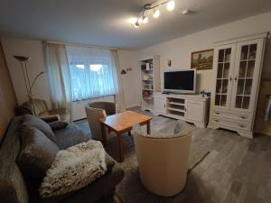 a living room with a couch and a table at HarzLiebe in Herzberg am Harz