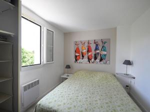 a bedroom with a bed and a window at Maison Saint-Clément-des-Baleines, 4 pièces, 6 personnes - FR-1-258-128 in Saint-Clément-des-Baleines