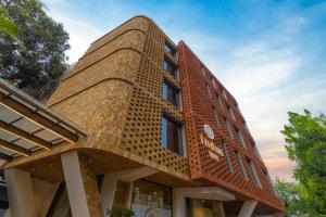 a brick building with a wavy roof at Indus Suites in Nagpur