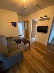 a living room with a couch and a table at Álftártunga Farm Guesthouse in Borgarnes