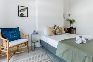 a bedroom with two beds and a chair with a pillow at Sunny Duplex W/ Pool & Balcony by LovelyStay in Carvoeiro