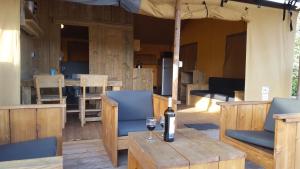 a bottle of wine sitting on a wooden table at Silver Coast Glamping luxury lodge in Alcobaça