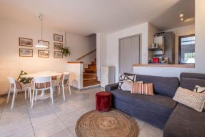 a living room with a blue couch and a table at Tennis / Pool / Barbecue in Bardolino