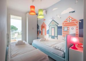 a bedroom with two beds with a mural of houses at Tennis / Pool / Barbecue in Bardolino +45 photos