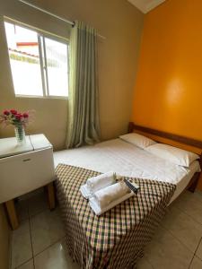 a small bedroom with a bed and a window at Pousada Lampião e Maria Bonita in Natal +63 photos