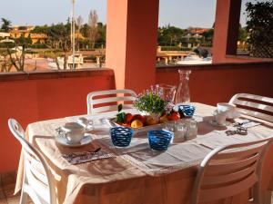 a table with a bowl of fruit on it at BellaSirmione Holiday Apartments in Sirmione