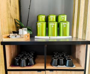 a shelf with green containers on top of it at ibis Rodez Centre in Rodez