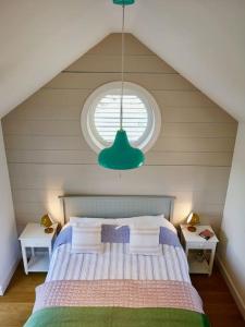 a bedroom with a large bed with a window at The little post house. A perfect village retreat, with stunning views. in Boscastle +39 photos