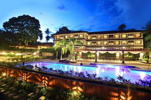 a hotel with a swimming pool at night at Hotel Tropika in Davao City