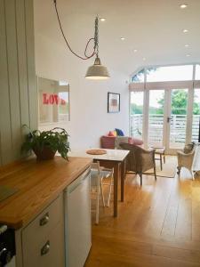 a kitchen and living room with a table and a dining room at The little post house. A perfect village retreat, with stunning views. in Boscastle