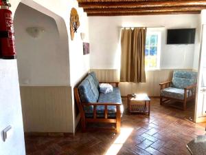 a living room with a couch and a chair at SOLAR DOS AVÓS in Guia