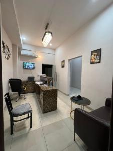 a living room with a couch and a desk and a tv at Wellawing Residency in Ludhiana +20 photos