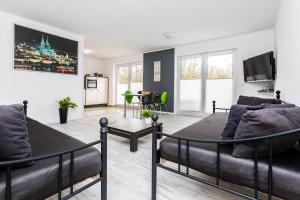 a bedroom with a bed and a living room at Apartment Köln Rath in Cologne