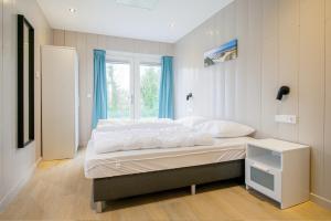 Ένα ή περισσότερα κρεβάτια σε δωμάτιο στο Vakantiehuis Vicky - Julianadorp aan Zee