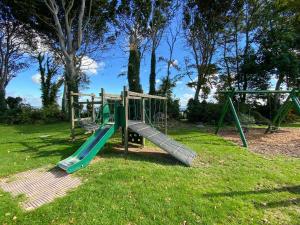a playground with a slide in a park at Coastal View in Kingsdown
