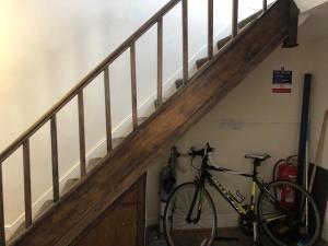 a bike is parked next to a staircase at Comfortable home, town centre, free parking,Multiple Rooms in Cheltenham