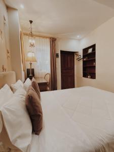 a large white bed in a hotel room at Five Seasons Pension in Nafplio