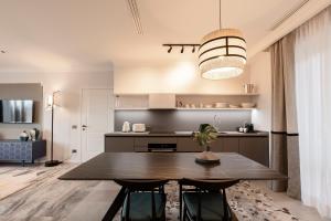 a dining room with a table and a kitchen at Be Mate Colosseo in Rome +28 photos