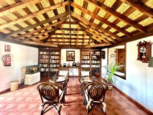 a living room with wooden ceilings and a table and chairs at Caserio rural antiguo con espectacular piscina y Wifi en San Miguel de Abona, Tenerife Sur in San Miguel de Abona