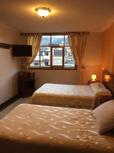 Postel nebo postele na pokoji v ubytování HOTEL El INDIO