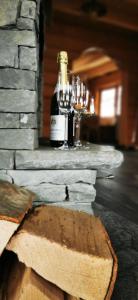 a bottle of wine and glasses on a table at Sarni Szlak in Zawoja