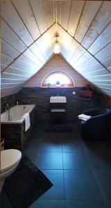 a bathroom with a tub and a sink and a toilet at Sarni Szlak in Zawoja