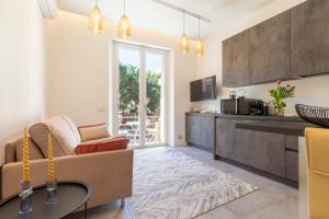 a living room with a couch and a table at Suite Cagliari in Cagliari