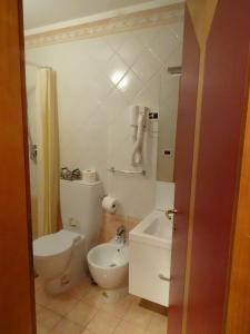 a bathroom with a white toilet and a sink at I Gioielli del Doge - Cannaregio in Venice