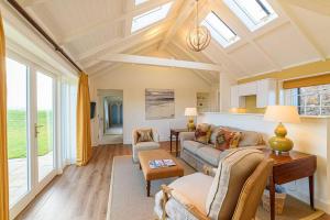 a living room with a couch and a table at Fenton Lodge in North Berwick