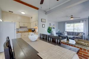 a kitchen and living room with a table and a couch at Titusville Vacation Rental with Private Pool! in Titusville
