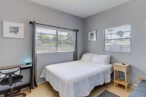 a bedroom with a bed and a desk and a window at Titusville Vacation Rental with Private Pool! in Titusville