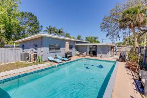 a swimming pool in front of a house at Titusville Vacation Rental with Private Pool! in Titusville