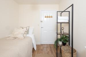 a bedroom with a bed and a shelf with towels at Luxury Apartment, Birmingham-Parking in Birmingham