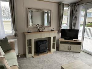 a living room with a fireplace and a television at The avenue, Waterside in Paignton