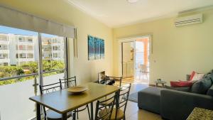 a living room with a table and a couch at Oura Oasis D by Check-in Portugal in Albufeira