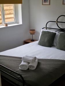 a bedroom with a bed with two towels on it at Seaview in Trevilley