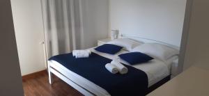 a bedroom with a bed with blue and white pillows at Villa Sole in Omišalj +58 photos