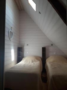 2 Betten in einem Zimmer mit Dachgeschoss in der Unterkunft Appartement la Roche Bernard in La Roche-Bernard