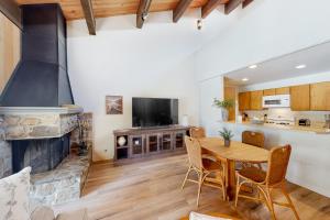 una sala de estar con una mesa y una chimenea en Kingswood Village 60, en Kings Beach
