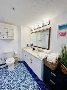 a bathroom with a toilet and a sink and a mirror at Daytona Beach Resort Private balcony Ocean Front in Daytona Beach