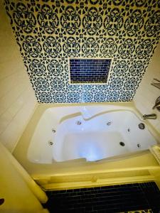 a bath tub in a bathroom with a tile ceiling at Daytona Beach Resort Private balcony Ocean Front in Daytona Beach