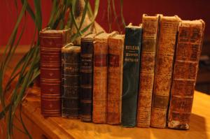 a group of old books sitting on a table at Hotel Boileau in Paris +53 photos